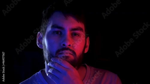 Portrait handsome man combing beard colorful neon led light. Fashion hipster prepare shave ultraviolet illuminance. Led lighting unshaven guy. Bearded people shaving neon illumination in ultra violet.