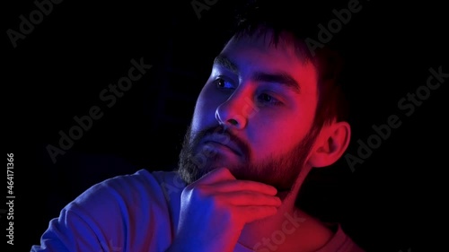 Portrait handsome man combing beard colorful neon led light. Fashion hipster prepare shave ultraviolet illuminance. Led lighting unshaven guy. Bearded people shaving neon illumination in ultra violet.