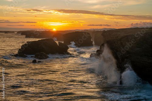 Playa de las Catedrales-huge, ocean waves crashing about rocky cliffs at sunrise photo