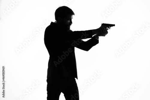 Konstfotografi businessmen with a pistol in hand crime hand gesture posing studio
