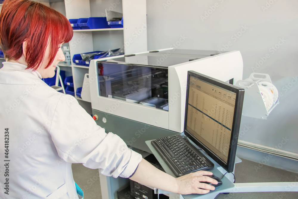 Woman controls automated soldering machine. Factory for the electronic production. Technological process of soldering and assembly chip components on pcb board. Woman controls automated soldering machine. Factory for the electronic production. Technological process of soldering and assembly chip components on pcb board.