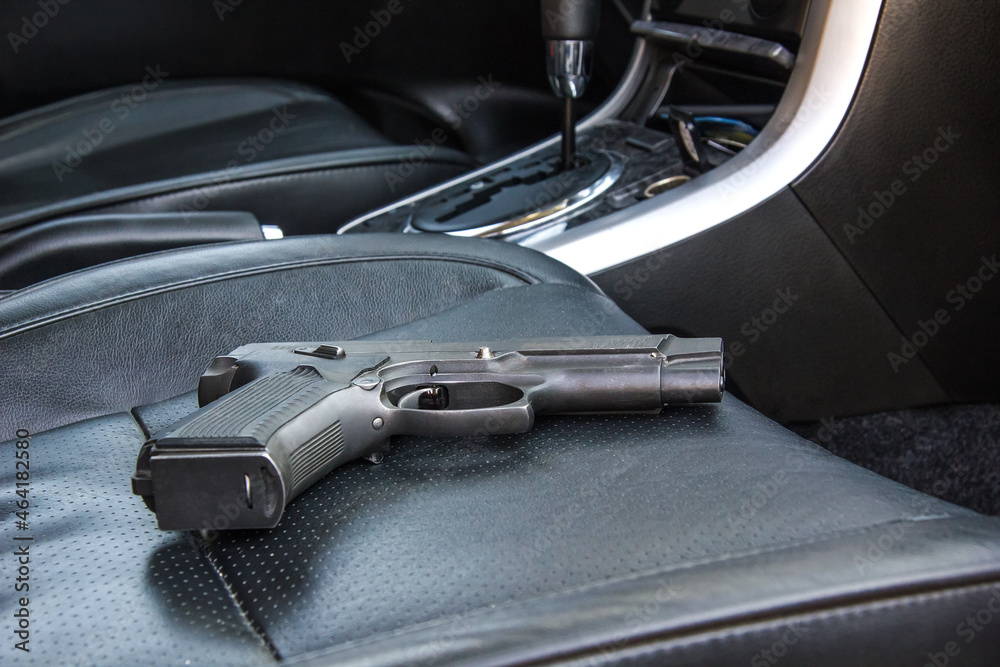 The gun is on the car seat. Criminal situation of the city district