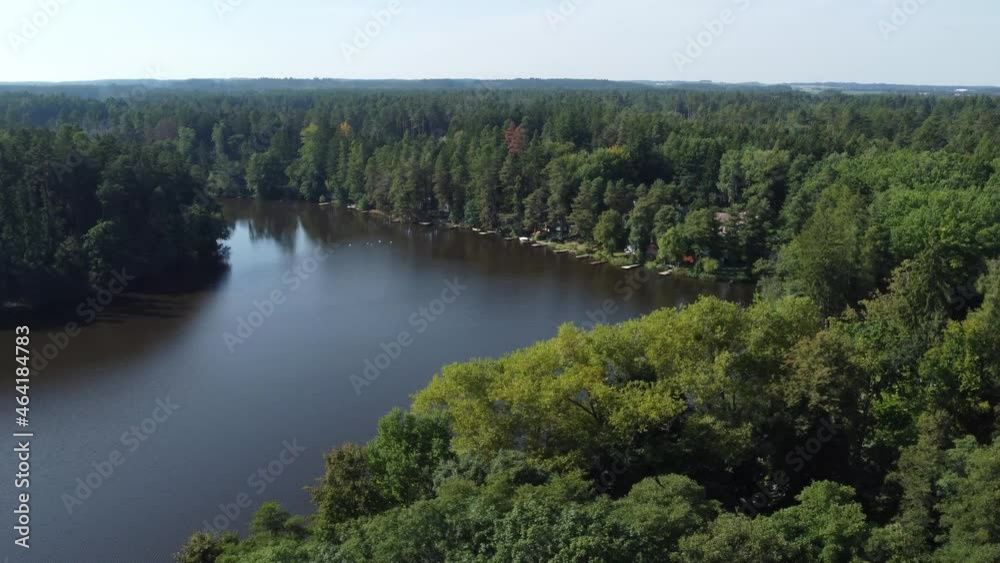 aerial view of a pond in the woods with small piers aerial view of a pond in the woods with small piers