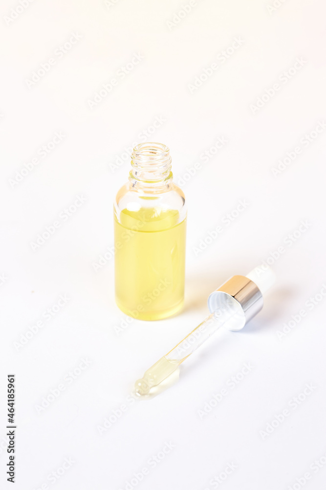 Pipette with essential oil over bottle on white background. Natural medicine concept. Aromatherapy Pipette with essential oil over bottle on white background. Natural medicine concept. Aromatherapy