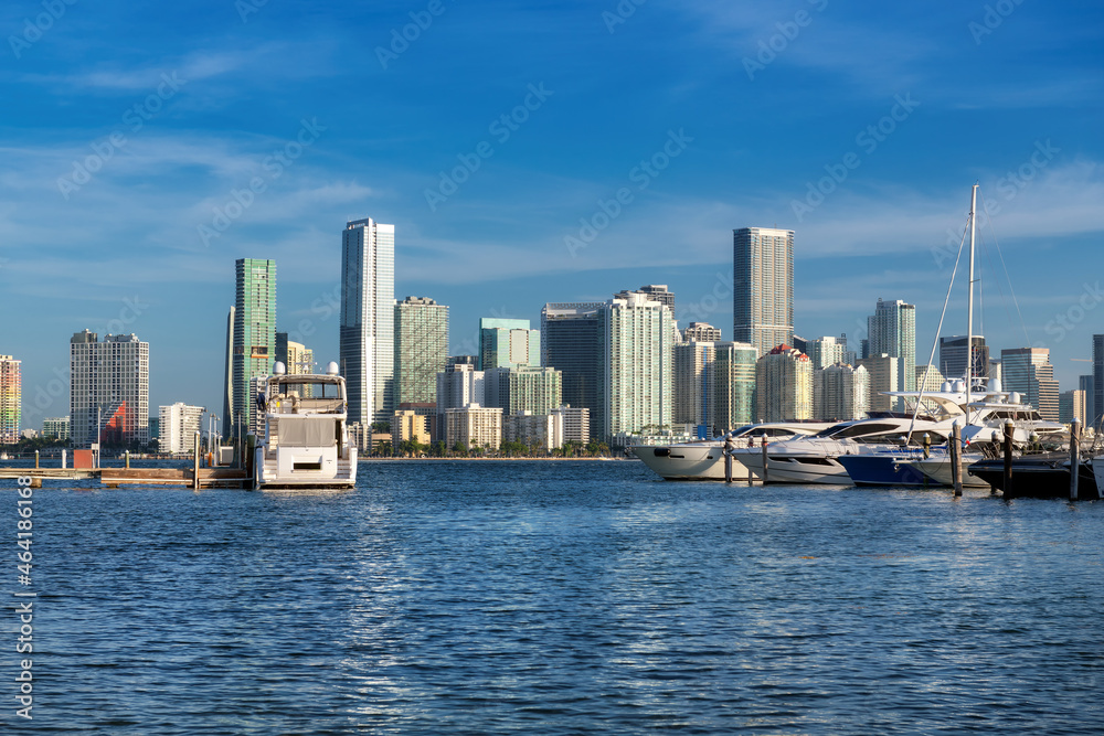 Luxury yachts moored in the harbor and Miami Downtown skyline at sunny morning, Miami, Florida.
