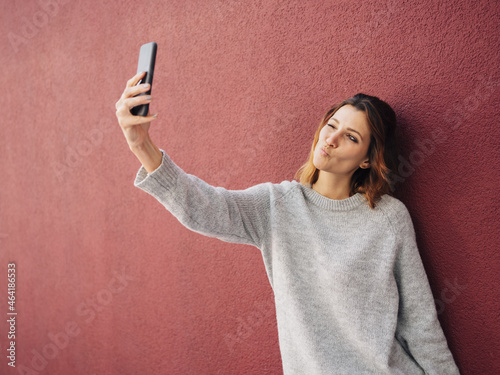 Sexy young woman winking and pouting for a selfie photo