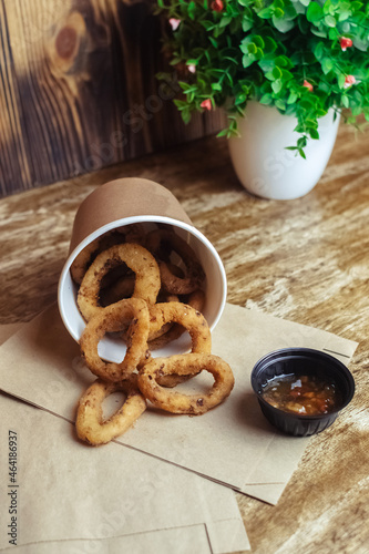 Close-up of onion rings in batter. Fried vegetables at a fast food restaurant. Vegetarian cuisine in a cafe. Meal for those who do not eat meat
