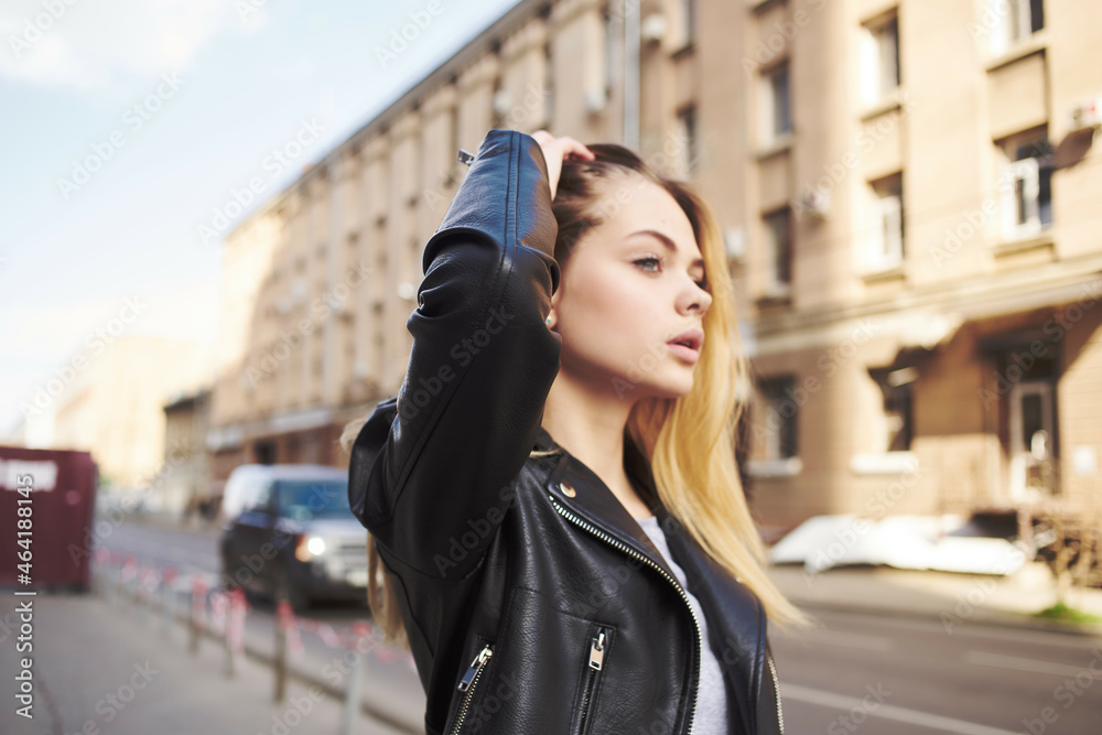 Obraz premium cute blonde in black jacket outdoors walk lifestyle
