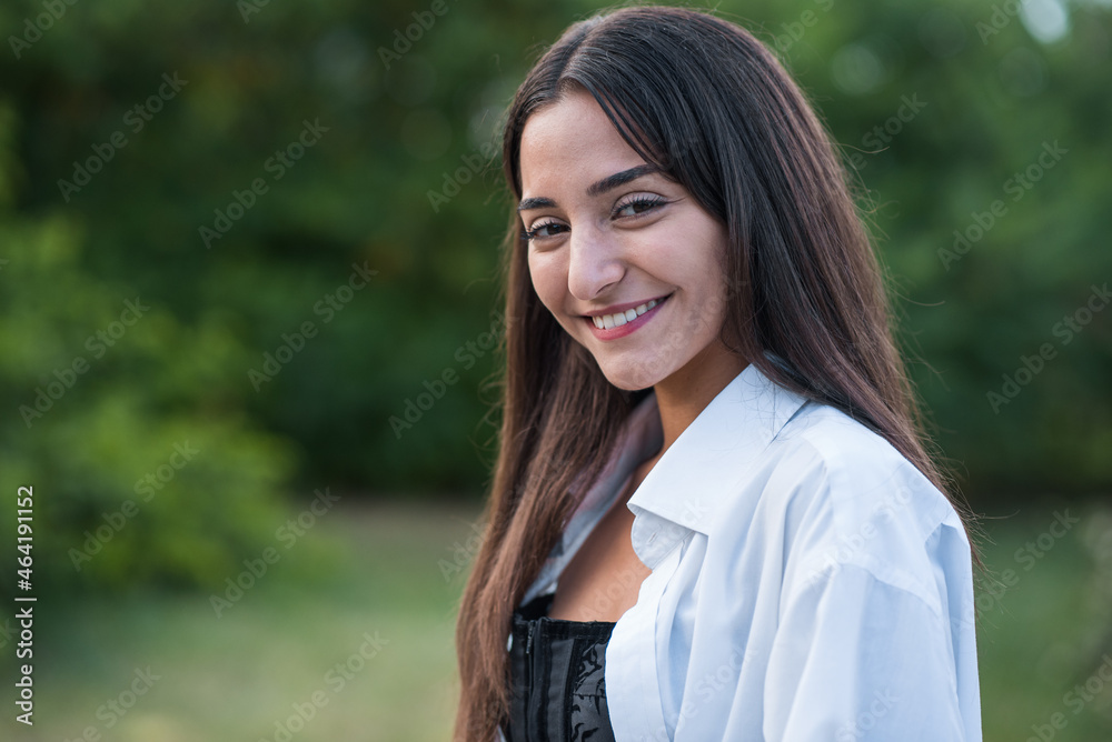 Portrait of a beautiful, happy and attractive Caucasian or Arabian brunette girl dressed in casual style. Portrait of a beautiful, happy and attractive Caucasian or Arabian brunette girl dressed in casual style.