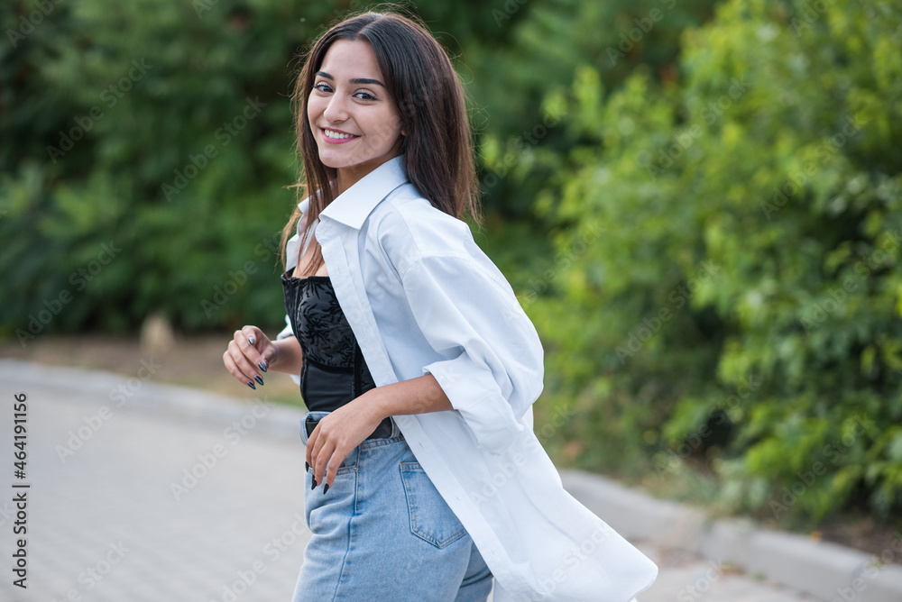 Portrait of a beautiful, happy and attractive Caucasian or Arabian brunette girl dressed in casual style. Portrait of a beautiful, happy and attractive Caucasian or Arabian brunette girl dressed in casual style.