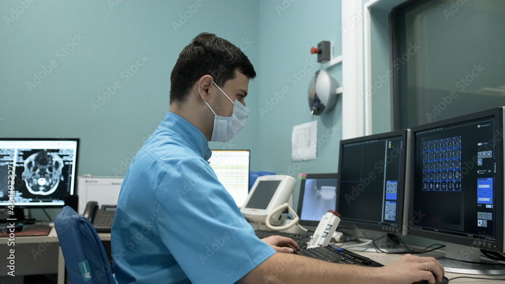 MRI operator makes the procedure for scanning the patient's brain