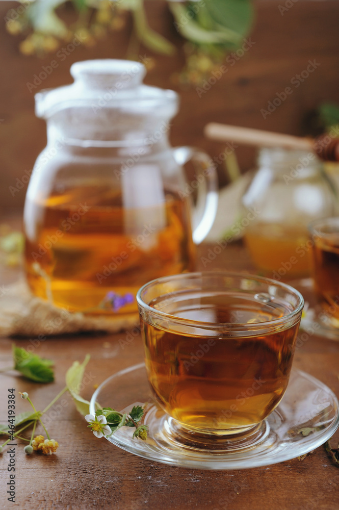 Hot herbal tea with chamomile and honey on wooden background Hot herbal tea with chamomile and honey on wooden background