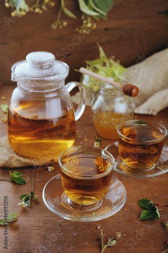 Hot herbal tea with chamomile and honey on wooden background 