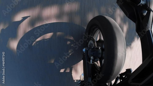 a motorcyle wheel perspective in summer on the road