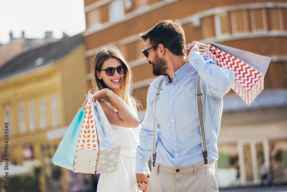 Fototapeta premium Beautiful couple enjoying shopping together in the city.