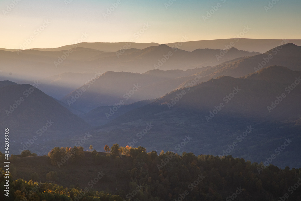 beautiful autumn landscape with hills at sunset