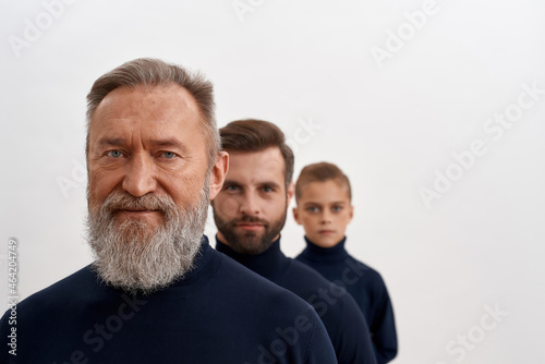 Фотография Portrait of three generations of men in row