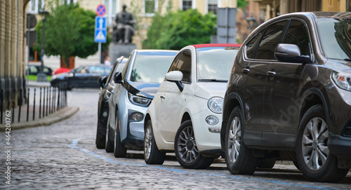 City traffic with cars parked in line on street side. © bilanol