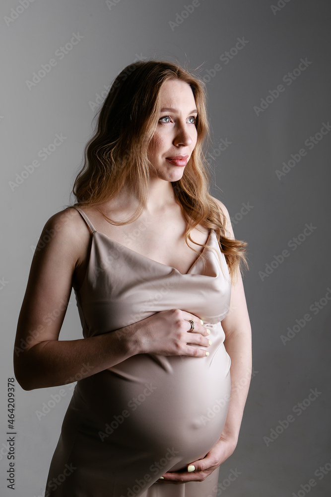 caucasian pregnant woman stroking her belly on white background. Copy space. The concept of healthy digestion, lifestyle, IVF caucasian pregnant woman stroking her belly on white background. Copy space. The concept of healthy digestion, lifestyle, IVF