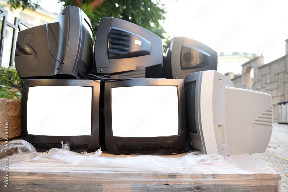 Dump trash can of old CRT TVs with white screens for adding images