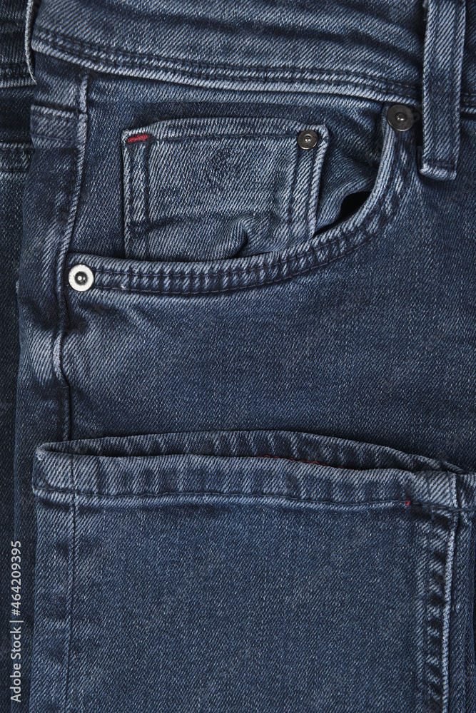 Close-up of dark blue jeans pockets.