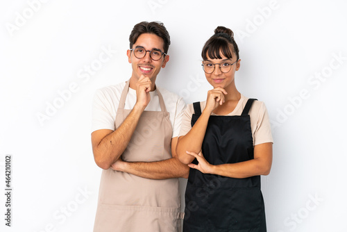 Restaurant mixed race waiters isolated on white background smiling and looking to the front with confident face