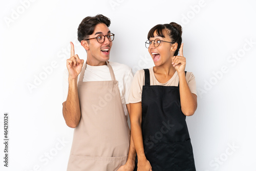 Restaurant mixed race waiters isolated on white background intending to realizes the solution while lifting a finger up