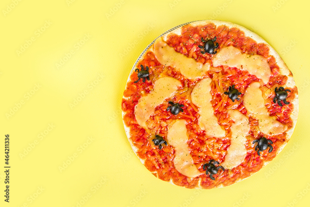 Halloween party trick or treat food, funny scary pizza in the style of Halloween characters - bats, spiders, jack o lantern pumpkin, cheddar, mozzarella and black cheese Halloween party trick or treat food, funny scary pizza in the style of Halloween characters - bats, spiders, jack o lantern pumpkin, cheddar, mozzarella and black cheese