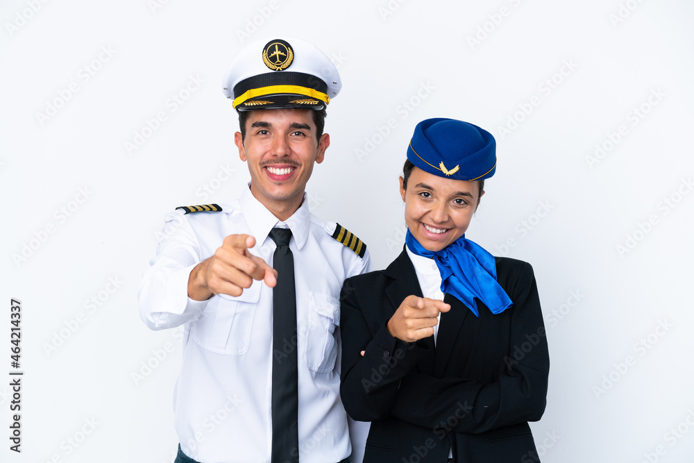 Airplane pilot and mixed race air hostess isolated on white background points finger at you with a confident expression Airplane pilot and mixed race air hostess isolated on white background points finger at you with a confident expression