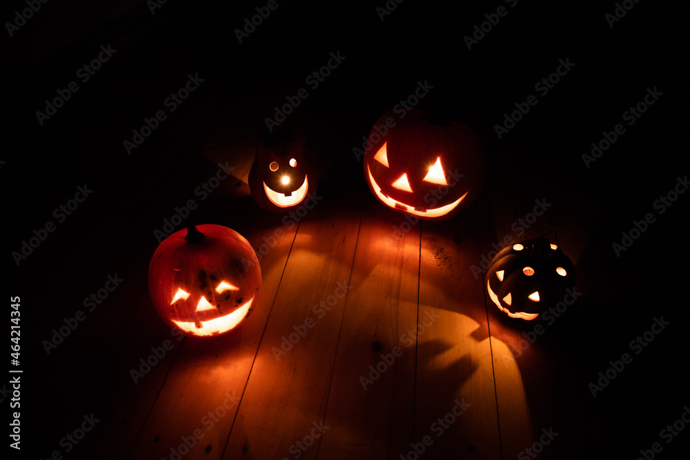 spooky Jack O' Lanterns on wooden table Glowing In Fantasy Night. Halloween Background