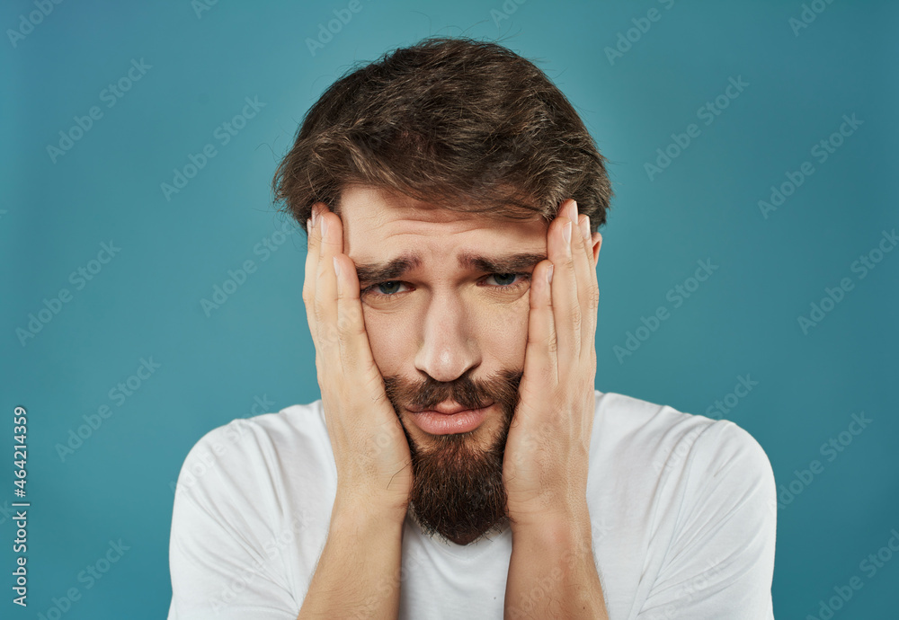 Man in a white t-shirt irritated facial expression Studio Man in a white t-shirt irritated facial expression Studio