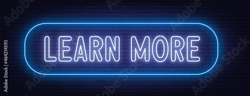 Learn More neon sign on brick wall background