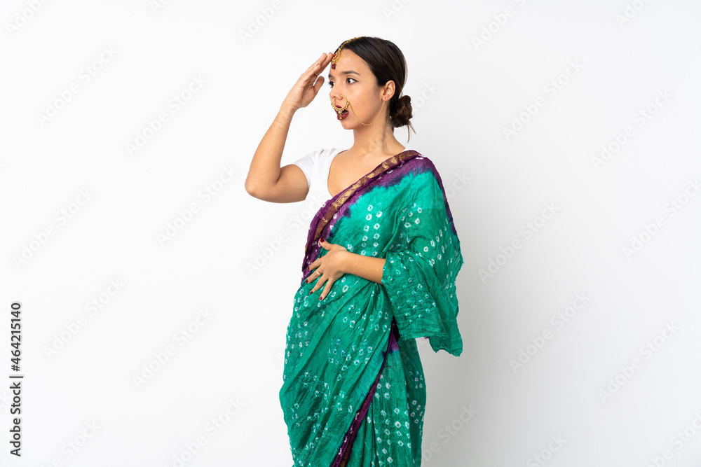Young indian woman isolated on white background doing surprise gesture while looking to the side Young indian woman isolated on white background doing surprise gesture while looking to the side