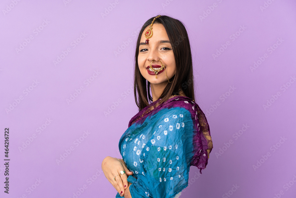 Young Indian woman isolated on purple background with arms crossed and looking forward Young Indian woman isolated on purple background with arms crossed and looking forward