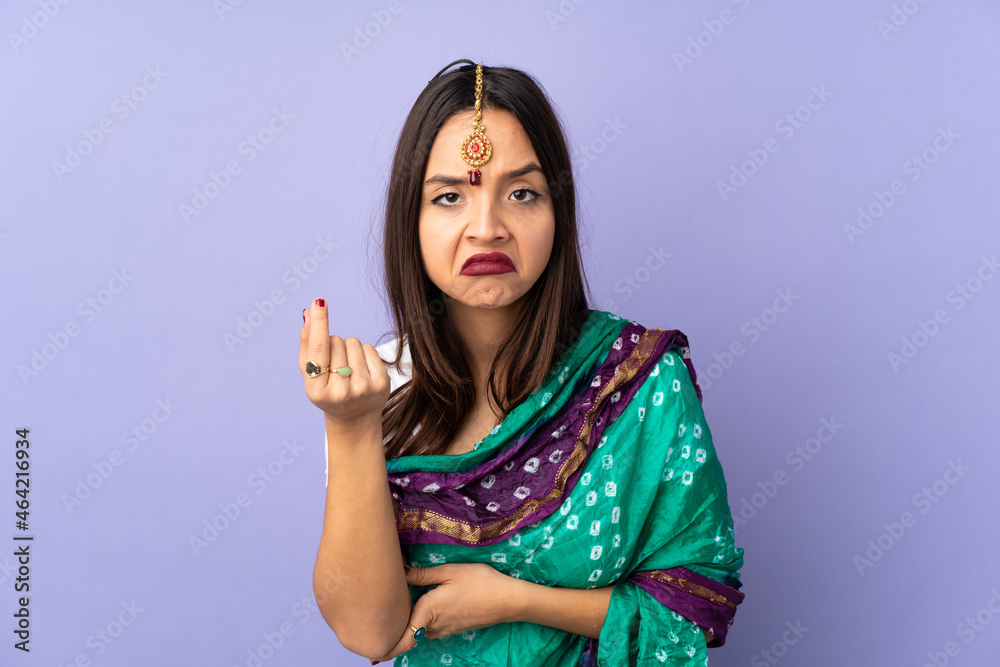 Young Indian woman isolated on purple background making Italian gesture Young Indian woman isolated on purple background making Italian gesture
