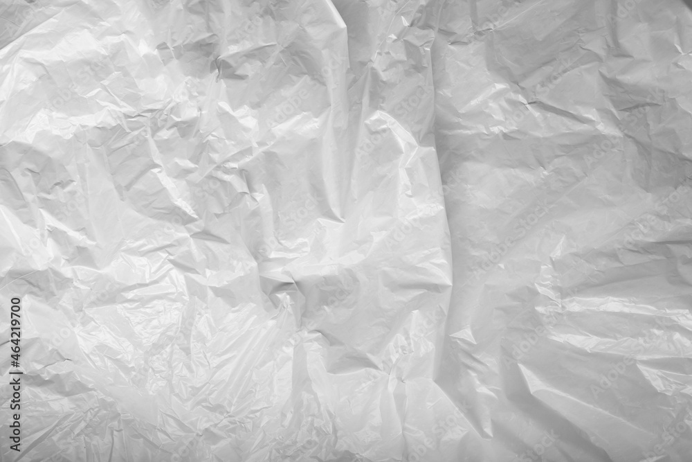 Obraz premium Reflecting light and shadow on creases and folds in scrunched white waxed paper