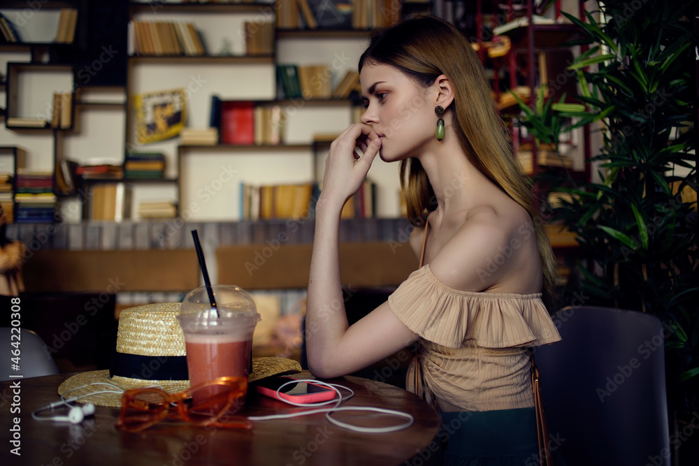 cheerful woman with a book in the hands of a cafe communication cheerful woman with a book in the hands of a cafe communication