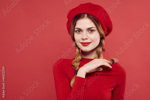cheerful woman with a red cap on his head glamor isolated background