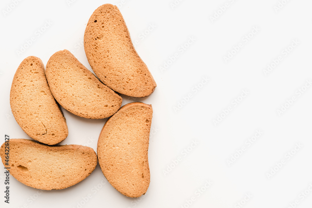 Breadcrumbs on a white plate. Rusks on a white background. Vanilla rusks. Breadcrumbs on a white plate. Rusks on a white background. Vanilla rusks.