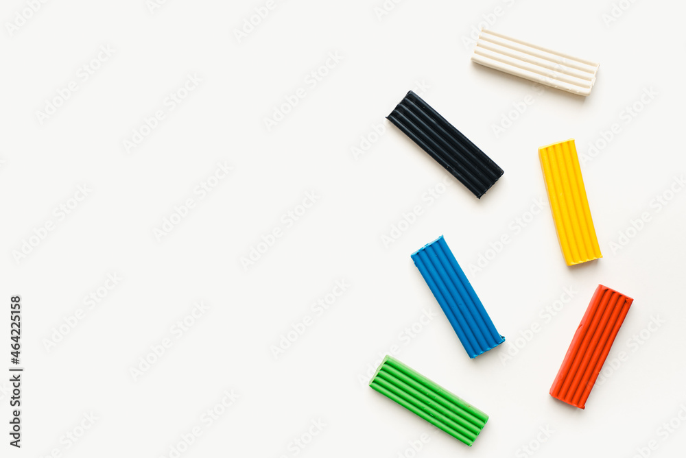 Colored plasticine on a white background. Pieces of plasticine. Colored plasticine on a white background. Pieces of plasticine.