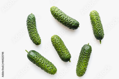 Green cucumbers on a white background. Pimpled cucumbers. 