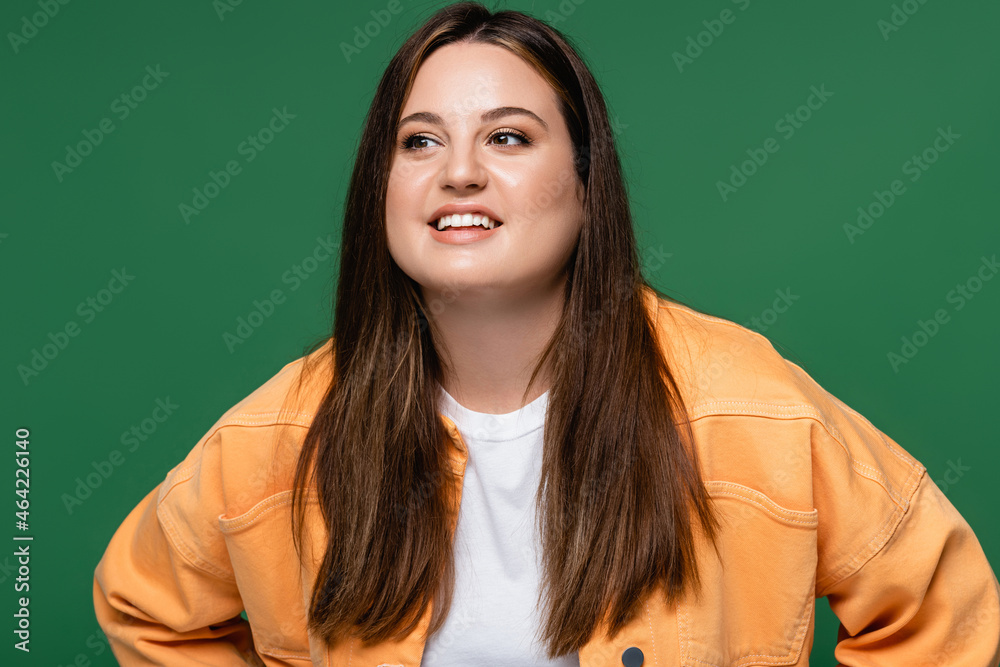 Fototapeta premium Pretty brunette woman with overweight looking away isolated on green
