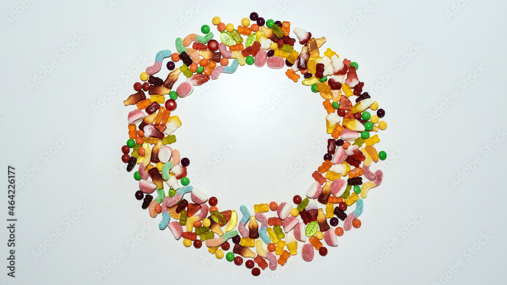 Flatlay of colorful sweets, jelly candies made from fruit juice, gelatin and sugar lying in the shape of circle isolated over white background Flatlay of colorful sweets, jelly candies made from fruit juice, gelatin and sugar lying in the shape of circle isolated over white background