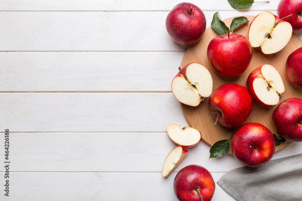 Fresh red apples with green leaves on table. cutting board with knife. Top view Fresh red apples with green leaves on table. cutting board with knife. Top view