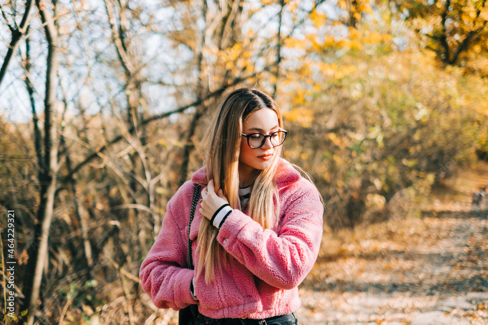 Portrait of attractive caucasian woman walking in a autumn park. Portrait of attractive caucasian woman walking in a autumn park.