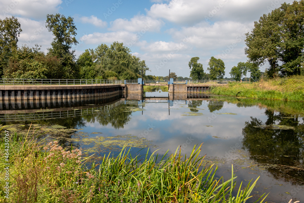 The beautiful flowing river called 'the Berkel' in the Achterhoek landscape, taken at a lock in the province of Gelderland
