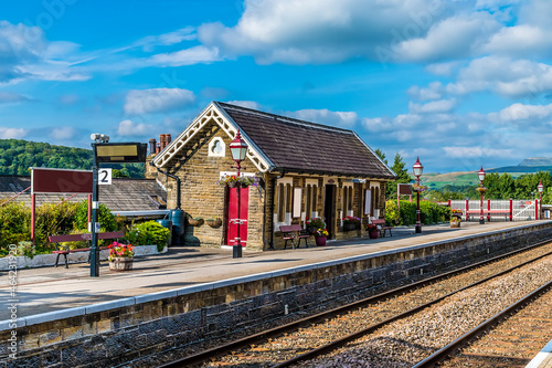 A view along the south platform at the railway station at Settle, Yorkshire in summertime