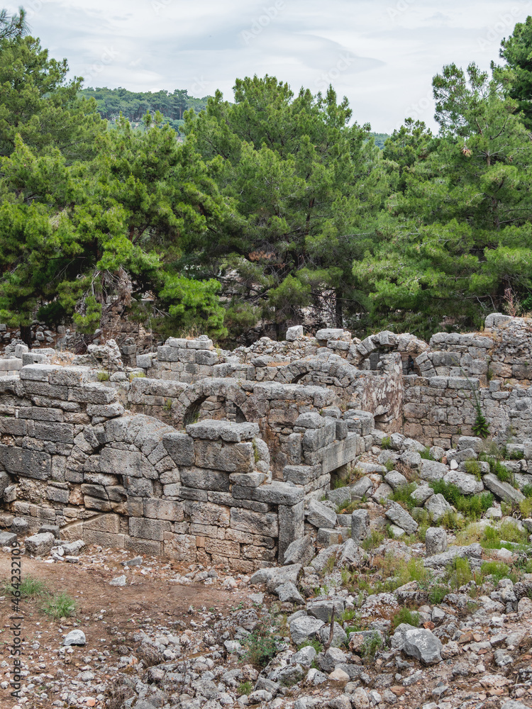 Ruins of ancient city Phaselis. Stones of damaged buildings. Architectural landmark of Turkey.