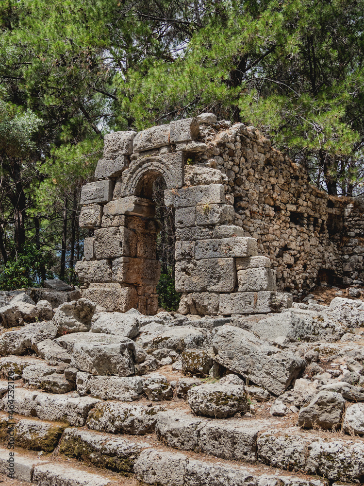 Ruins of ancient city Phaselis. Stones of damaged buildings. Agora of Domitian. Turkey.