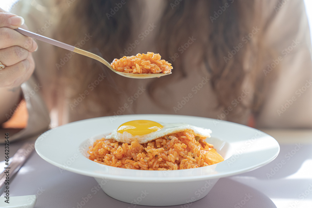 Kimchi fried rice with eggs and a spoon with kimchi fried rice. Kimchi fried rice with eggs and a spoon with kimchi fried rice.